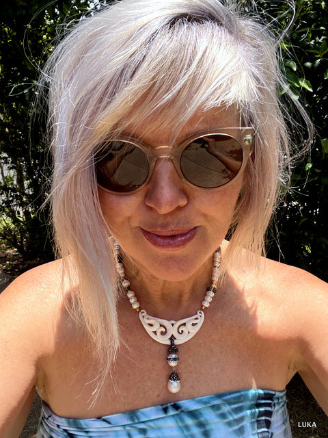 I am wearing the necklace in the shortest setting - it can be extended via the extender chain by 15-18cm